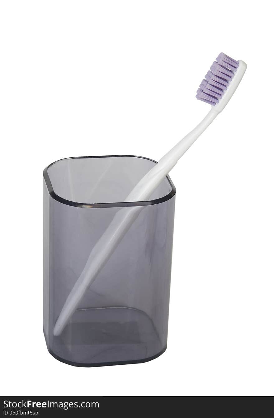 Tooth-brush in a plastic beaker on a white background