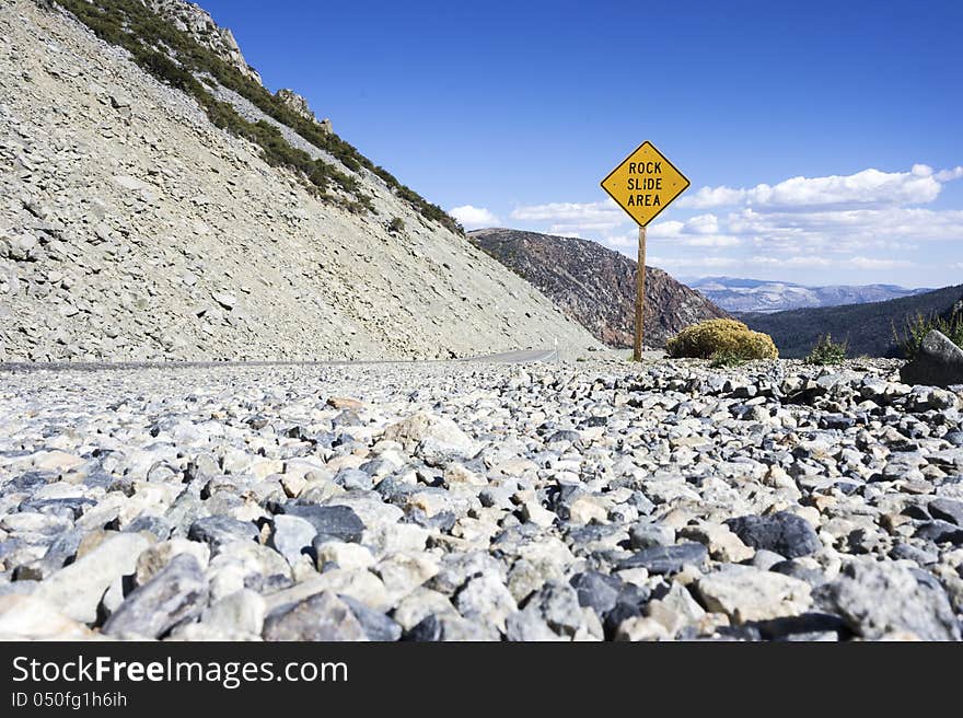 Rock Slide Area Sign Placed in Mountain LAndscape