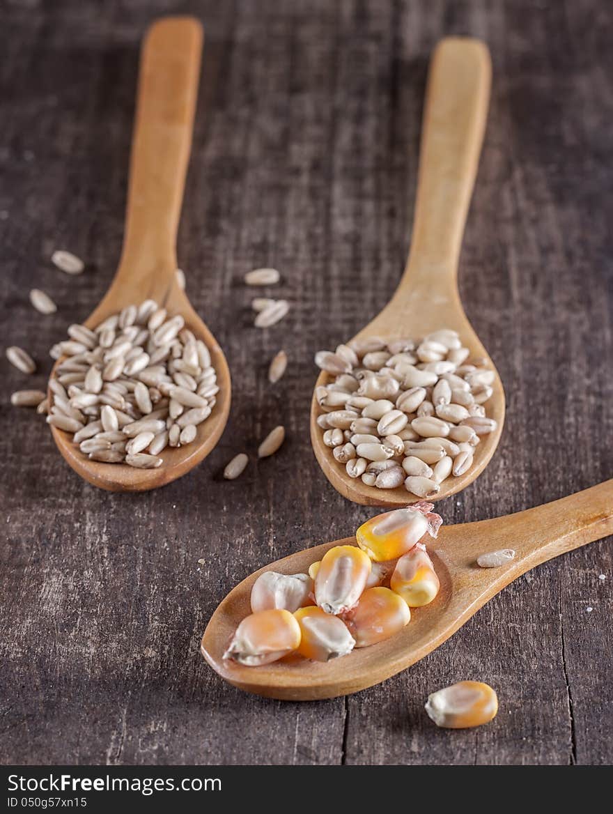 Sweet corn on a wood spoon  on old wooden plank