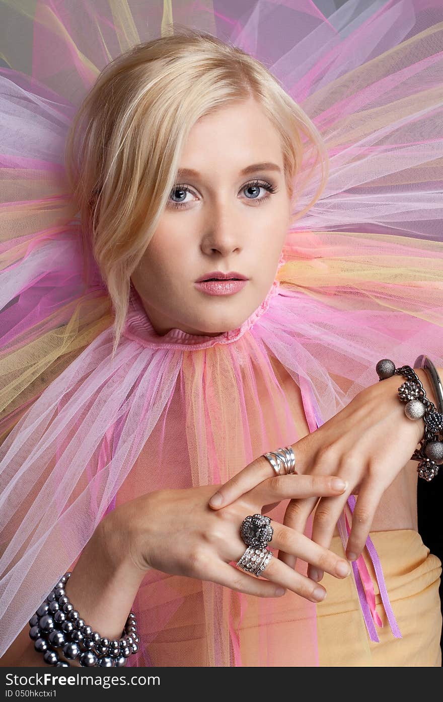 An image of a pretty teenager wearing a pastel tutu around her neck. An image of a pretty teenager wearing a pastel tutu around her neck