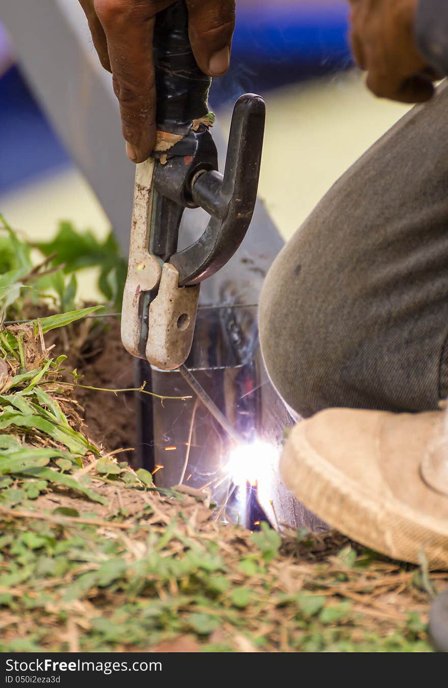 Welder welding elements at the construction site