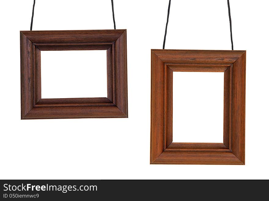 Two wooden photographic frame hanging on black cord. Two wooden photographic frame hanging on black cord