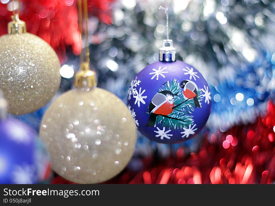 Christmas toy against the background of new year's tinsel. Christmas toy against the background of new year's tinsel