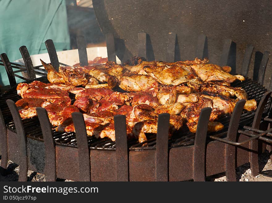 Fillet pig and roast chicken legs on grill for picnic