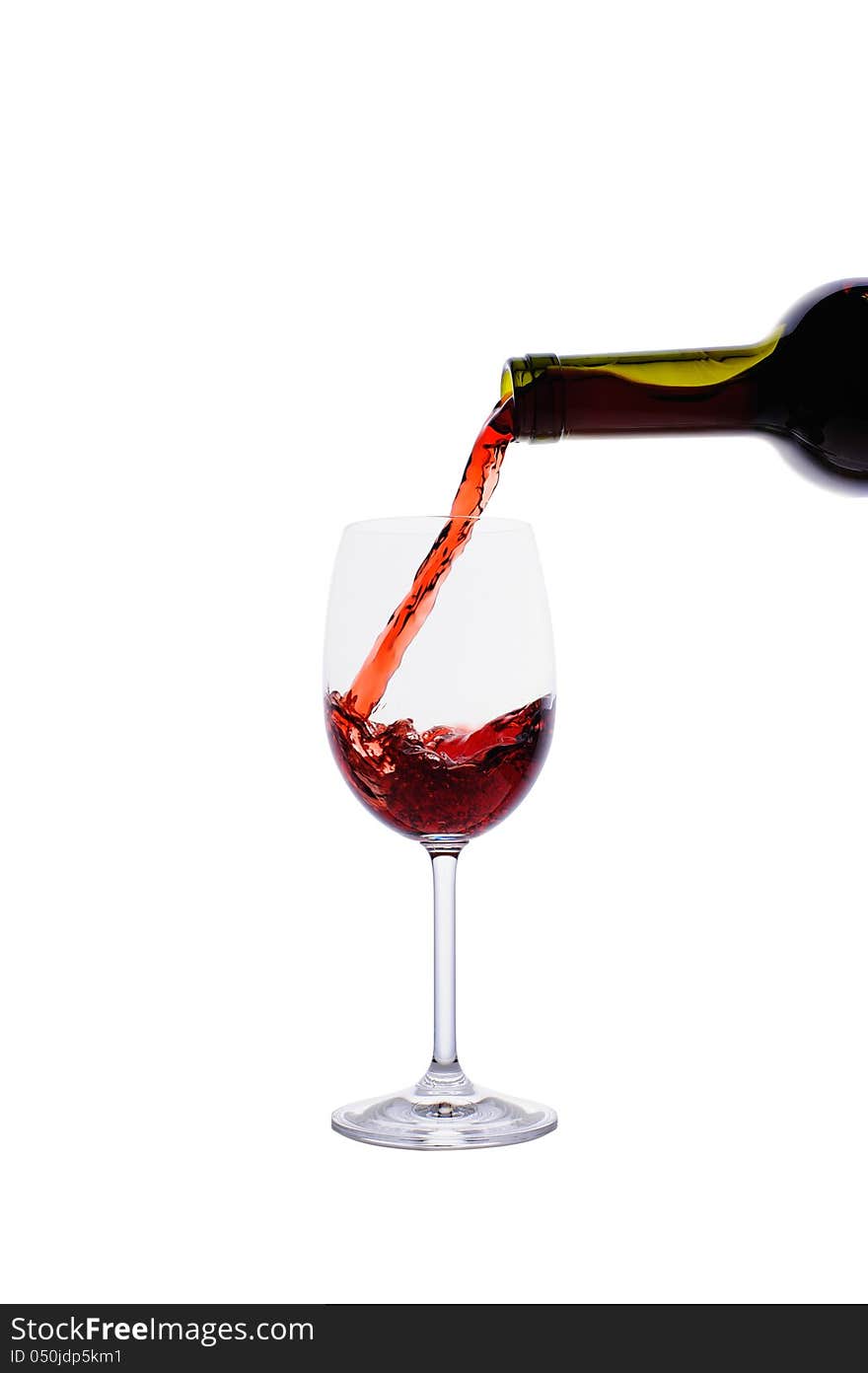 Red wine pouring into wine glass isolated on white background