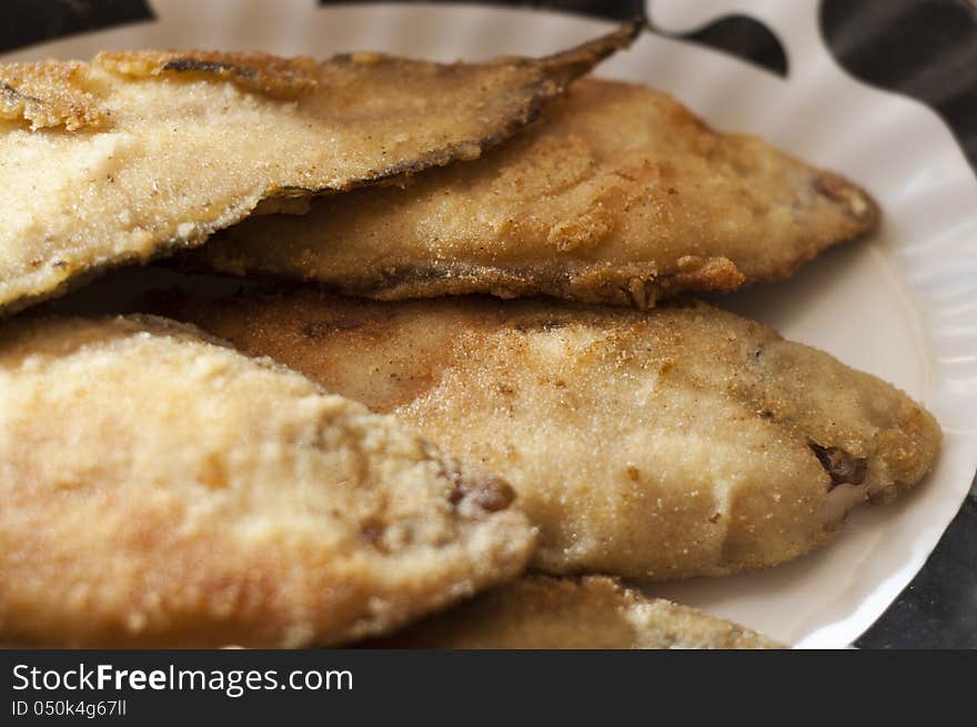 Breaded and  Frying plaice fish on a plate. Breaded and  Frying plaice fish on a plate