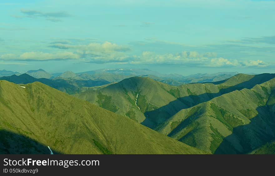 Landscape northern mountains with snow and spring greens. Landscape northern mountains with snow and spring greens.