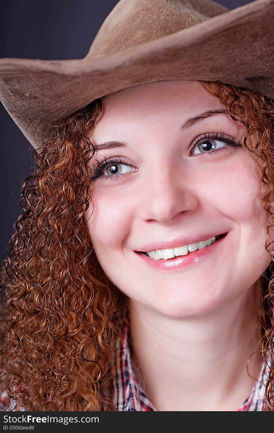 Portrait of girl smiling in a cowboy hat. Portrait of girl smiling in a cowboy hat