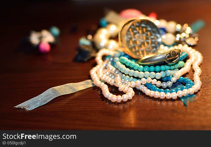 Table is full of beaded jewelry. Table is full of beaded jewelry