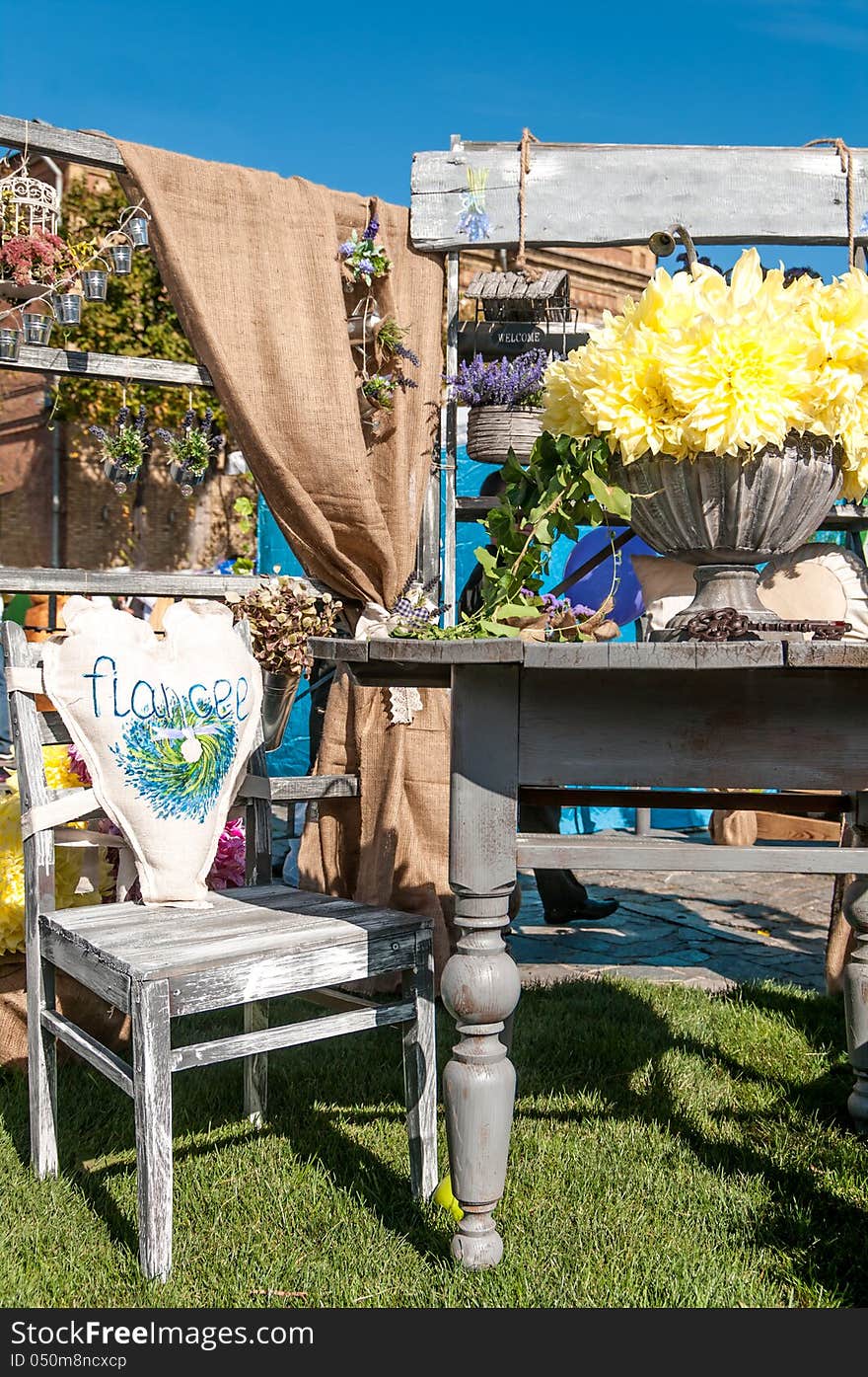 The interior of the old furniture with a bouquet of flowers on the table. The interior of the old furniture with a bouquet of flowers on the table