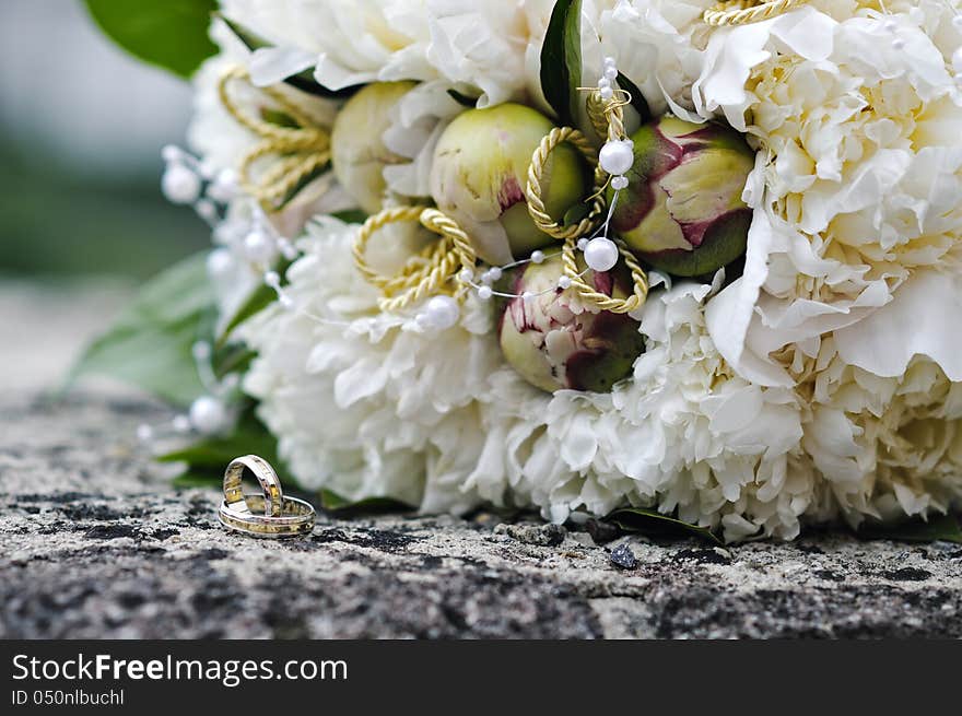 Wedding bouquet and golden rings