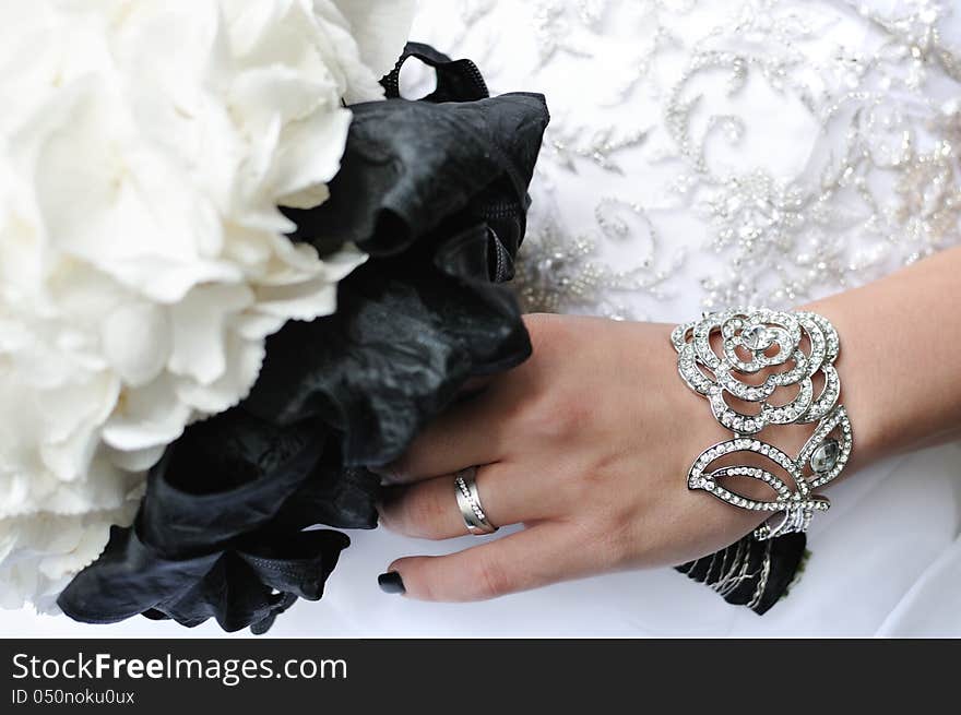 Wedding bouquet, hand and golden rings