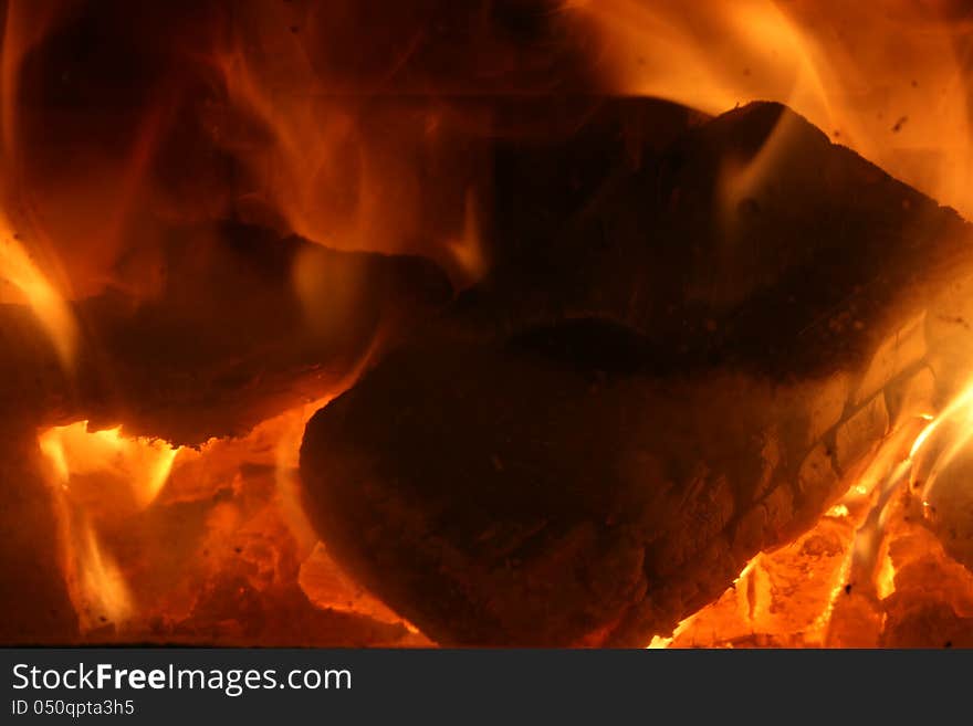 Hot coals inside a fireplace.