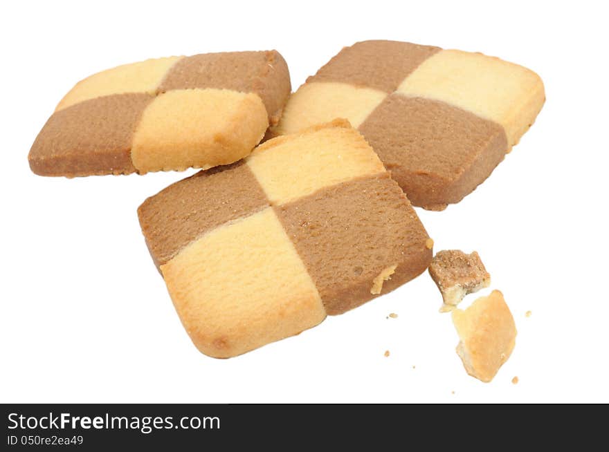 Square check board cookies with crumbs isolated on a white background. Square check board cookies with crumbs isolated on a white background