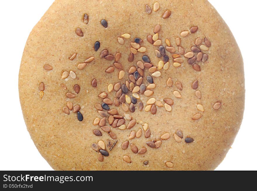 A close-up of whole-wheat bun with tan sesame seeds. A close-up of whole-wheat bun with tan sesame seeds