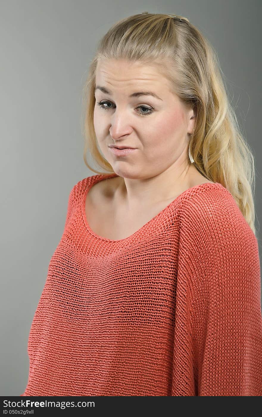 Woman shows disgust. The photo was made in studio.