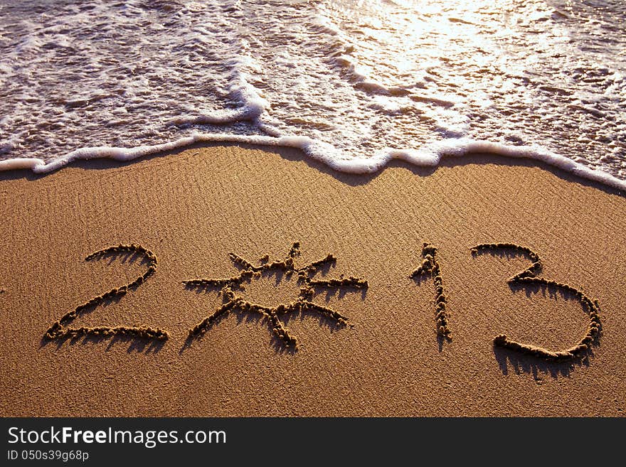 Sunny 2013, digits written on the sand. Sunny 2013, digits written on the sand