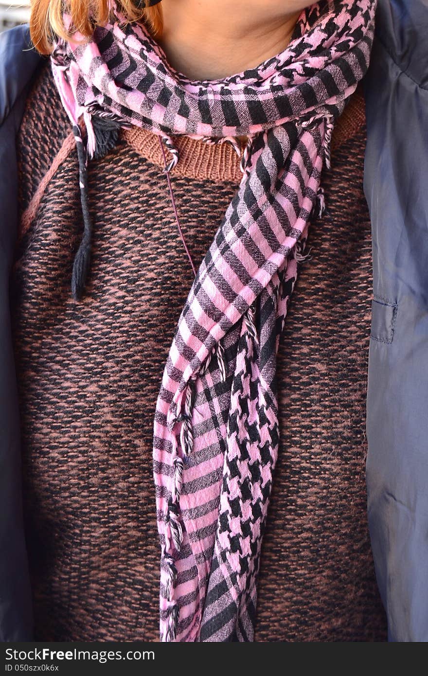 Woman with checkered scarf around his neck. Woman with checkered scarf around his neck.