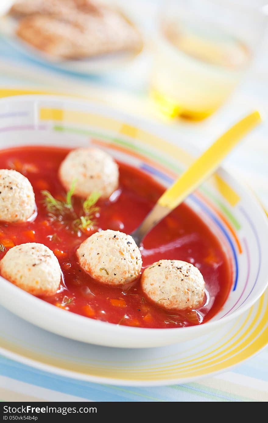 Tomato soup with vegetables and turkey meatballs, selective focus