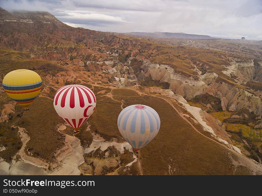 Three bright floating balloons in the cloudy day. Three bright floating balloons in the cloudy day