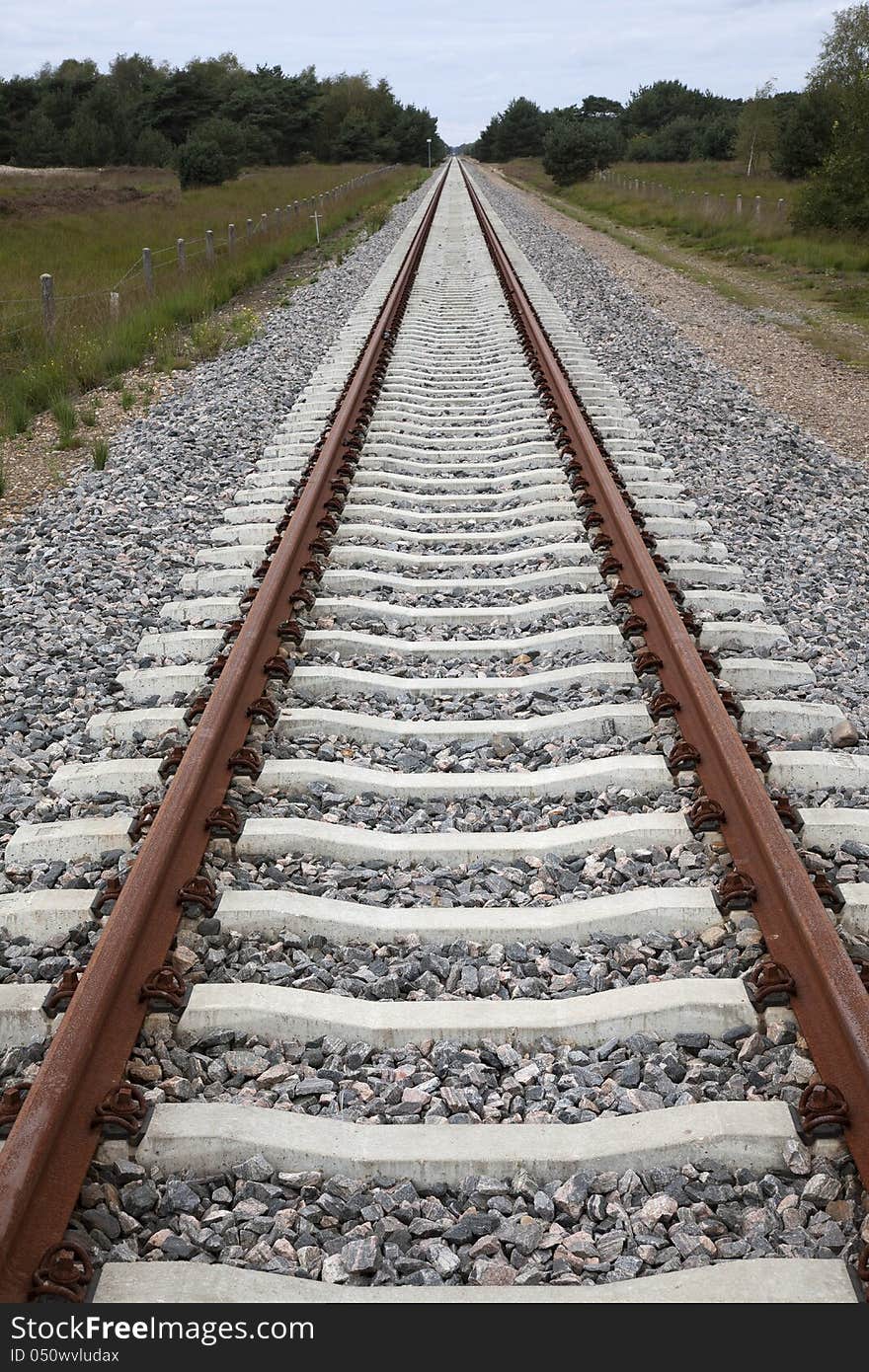 Renewed line with concrete sleepers far behind the horizon. Renewed line with concrete sleepers far behind the horizon