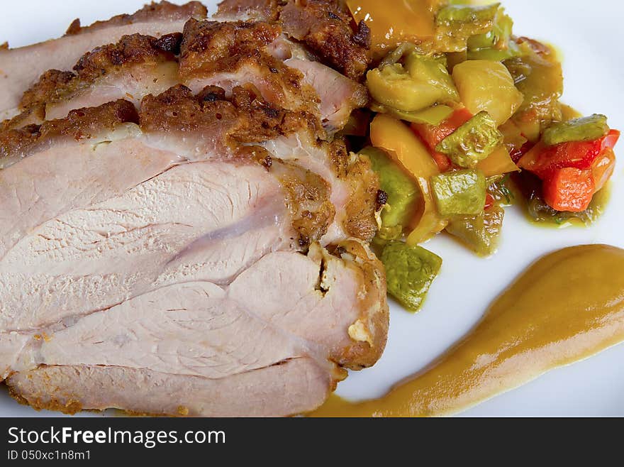 Sliced ​​turkey breast with vegetables and sauce, close-up. Sliced ​​turkey breast with vegetables and sauce, close-up.