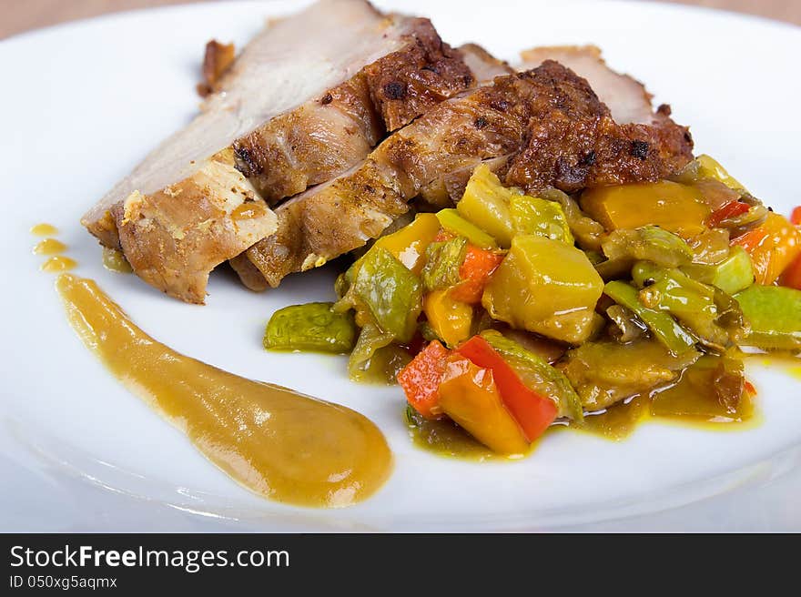 Sliced ​​turkey breast with vegetables and sauce, close-up. Sliced ​​turkey breast with vegetables and sauce, close-up.