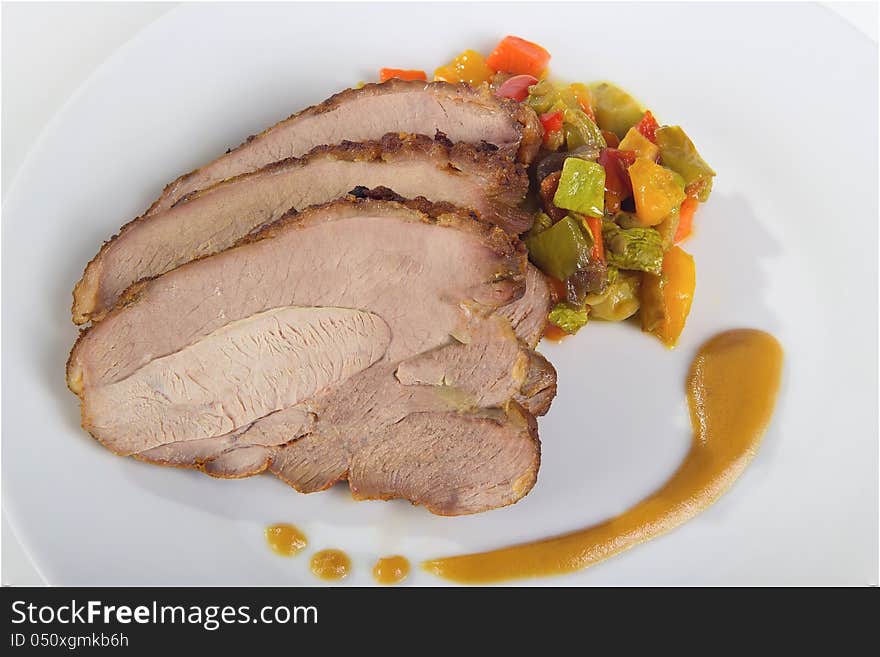 Sliced ​​turkey breast with vegetables and sauce, close-up. Sliced ​​turkey breast with vegetables and sauce, close-up.