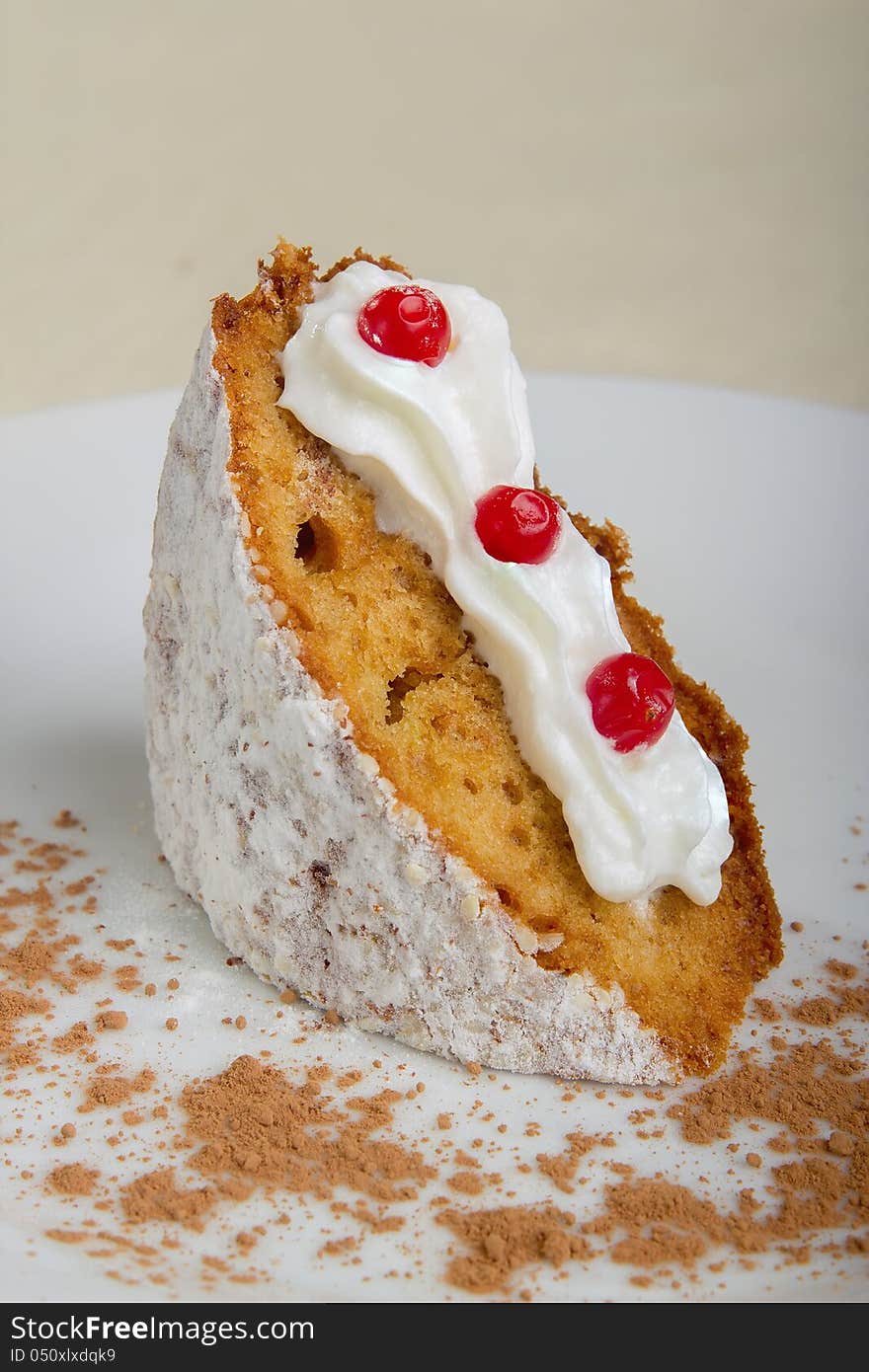 Piece of cake on a white plate with berries