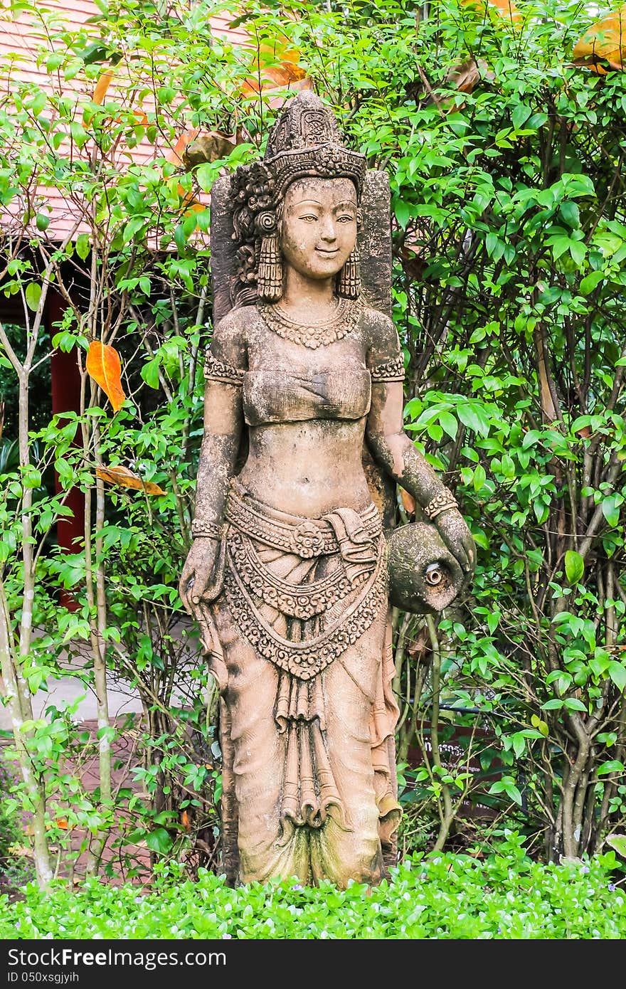 Ancient Cambodian style woman sculpture in Thai botanic garden