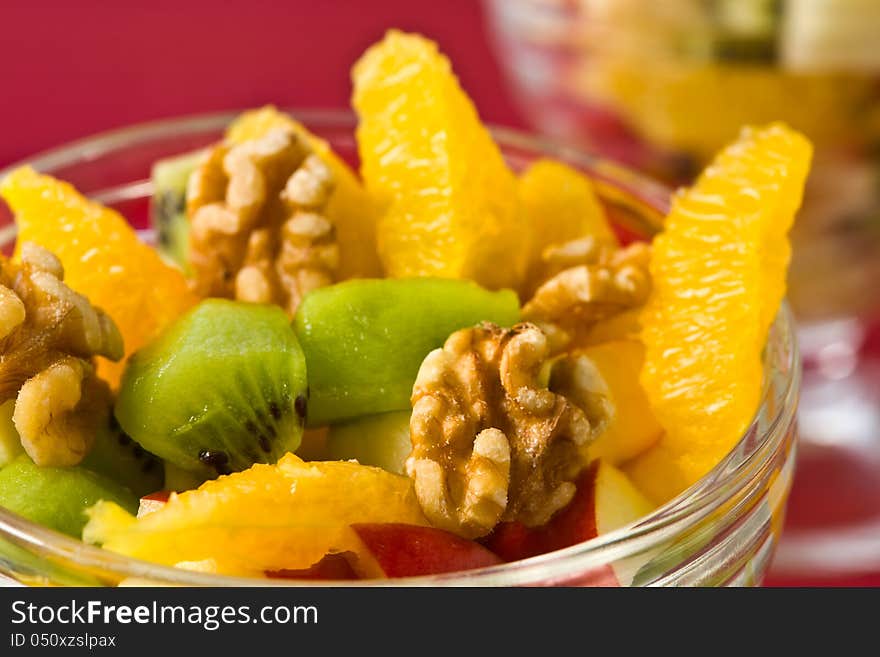 Fruit salad with kiwi, orange, apple and walnut. Fruit salad with kiwi, orange, apple and walnut