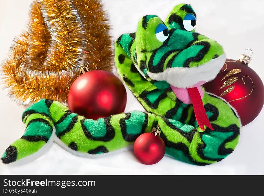 New Year symbol snake with Christmas balls and garland isolated on white