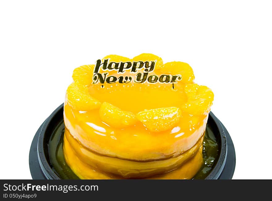 Orange cake with golden happy new year text  isolated