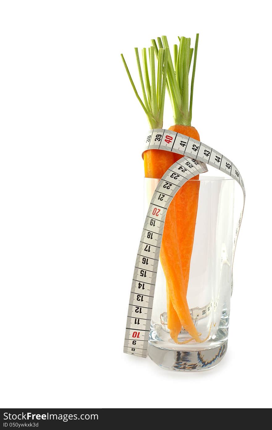 Fresh whole carrots in glass with measuring tape isolated on white background. Fresh whole carrots in glass with measuring tape isolated on white background