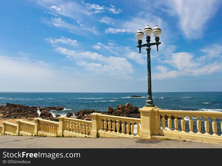 Street lamp on a promenade near ocean