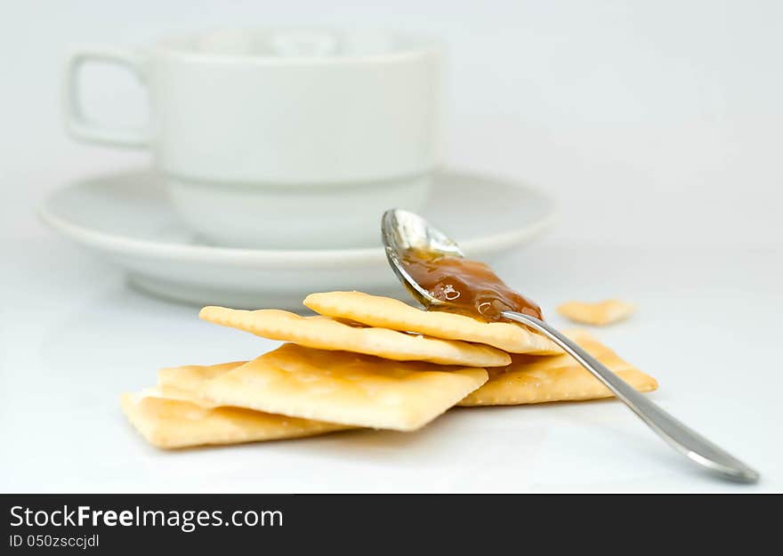 Saltine crackers and jam On a white background.