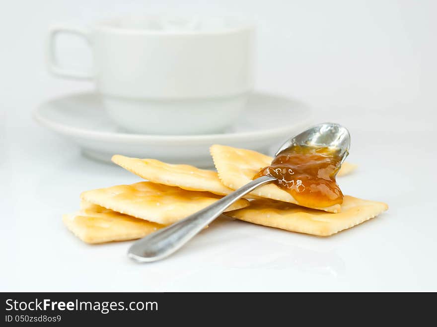 Saltine crackers and jam On a white background.