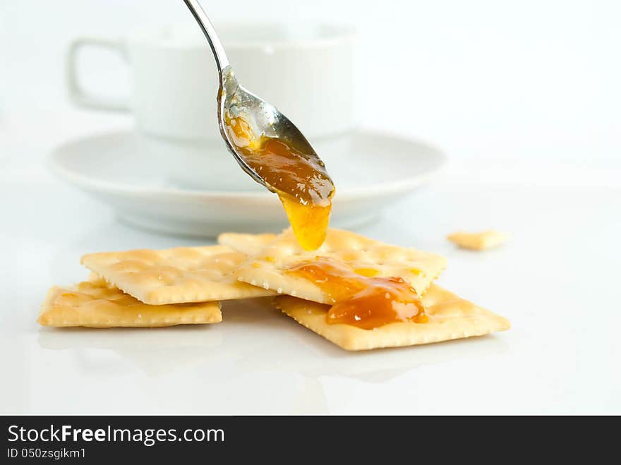 Saltine crackers and jam On a white background.