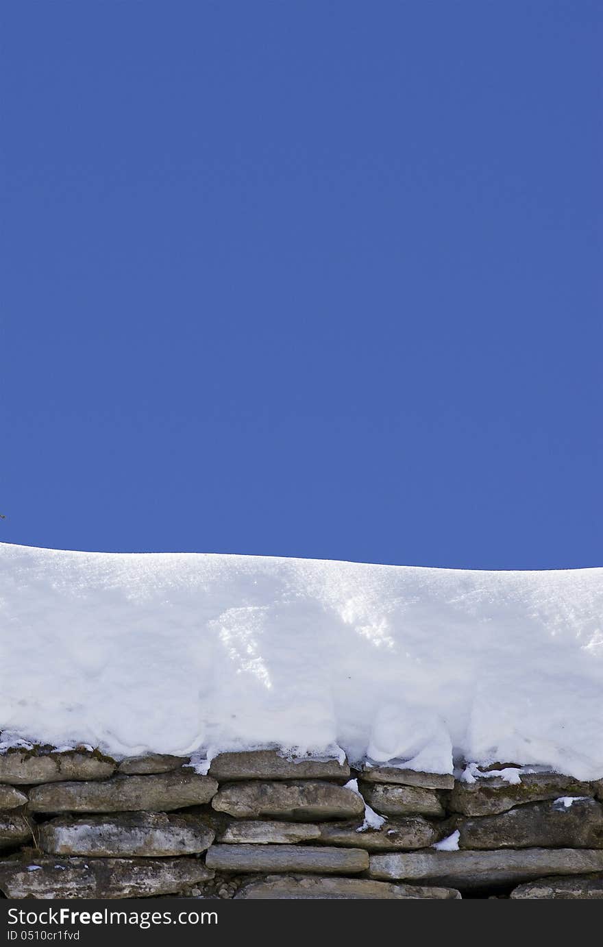 Rock structure with snow on it over blue clear sky. Rock structure with snow on it over blue clear sky