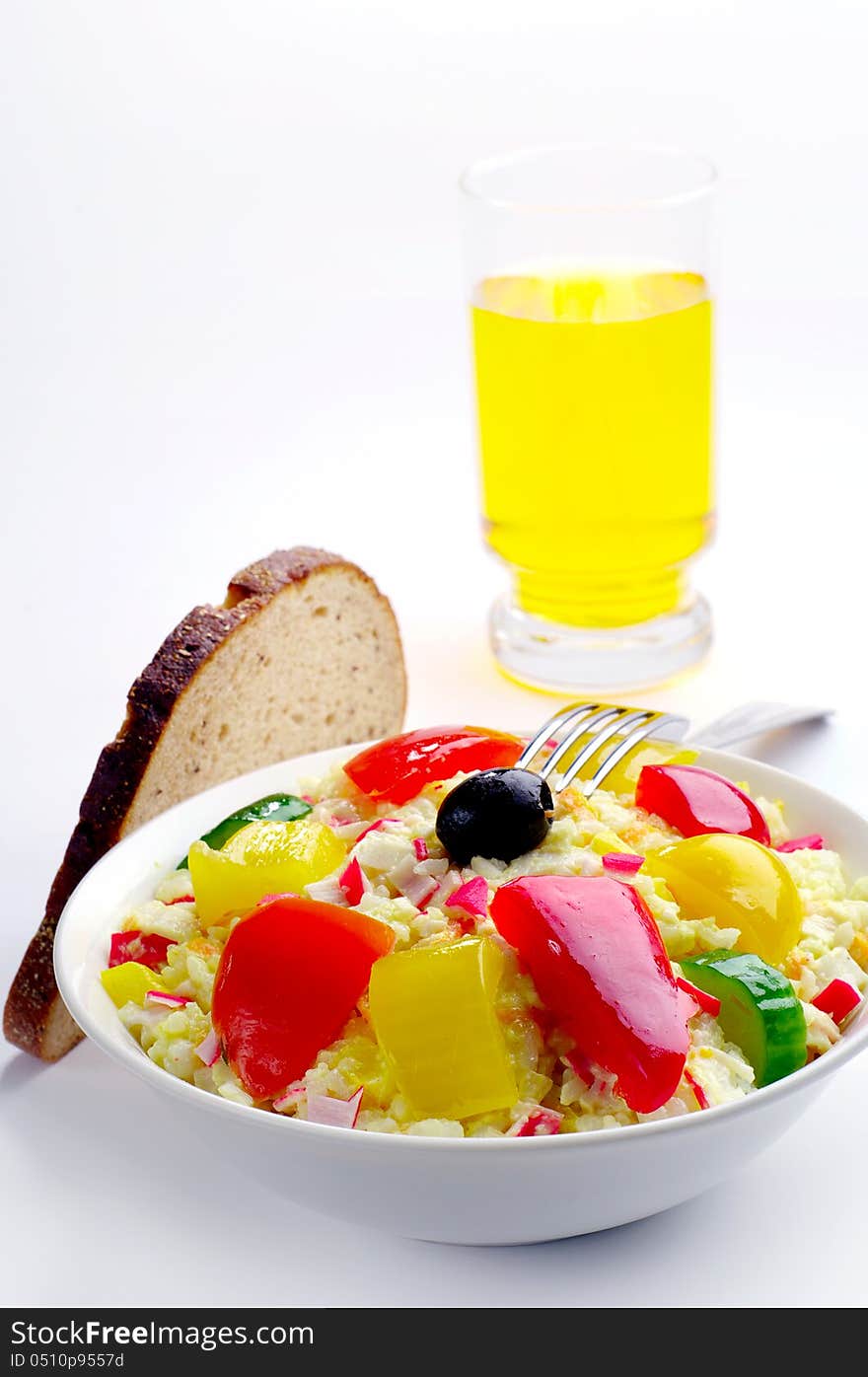 Salad with crab sticks, rice, vegetables and a glass of juice. Salad with crab sticks, rice, vegetables and a glass of juice