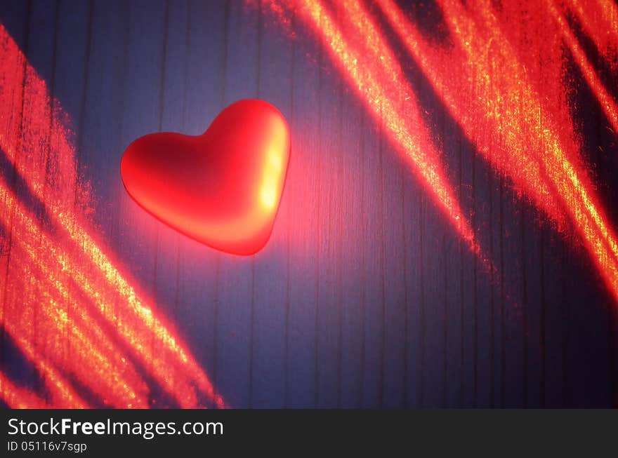 Red heart in the light of the laser