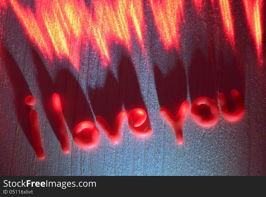 Sign of love from the polymer in the light of the laser on a wooden board. Sign of love from the polymer in the light of the laser on a wooden board