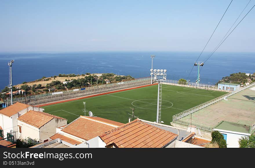 Football stadium located on the bank above and below sea house