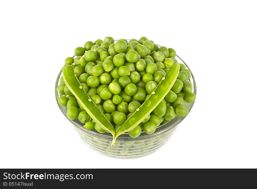 Pea balls in glass bowl on white background.