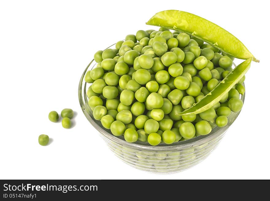 Pea balls in glass bowl on white background.