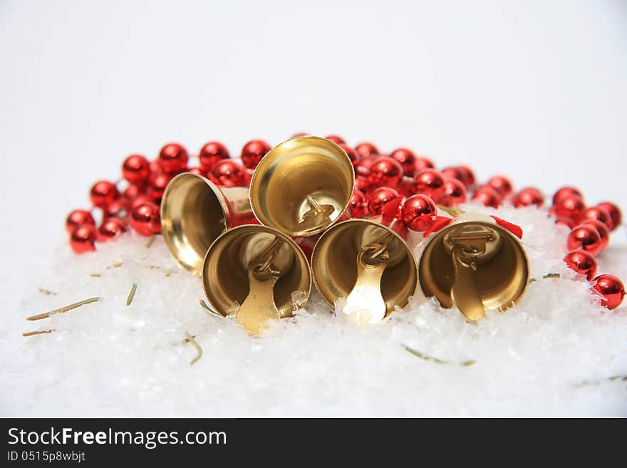 Gold christmas bells on snow. Gold christmas bells on snow