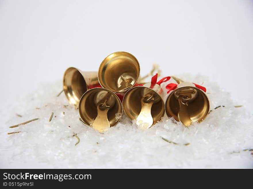 Gold christmas bells on snow. Gold christmas bells on snow