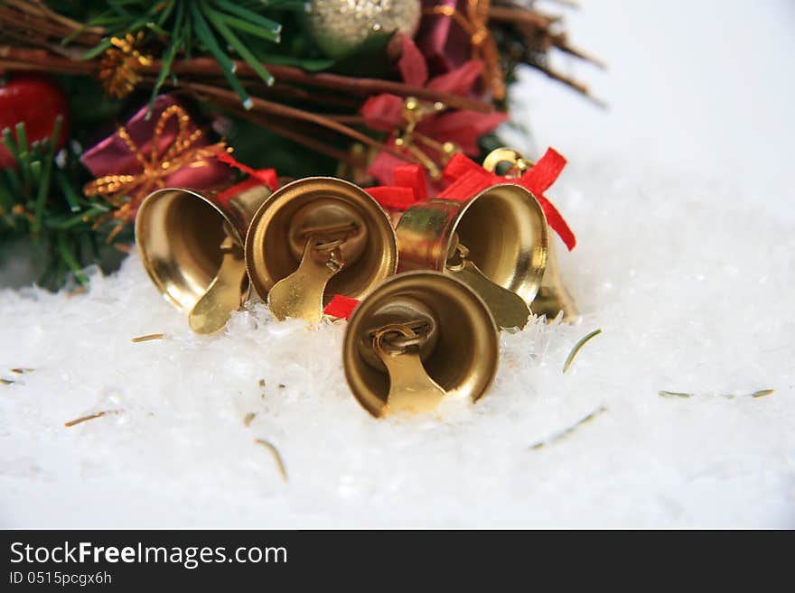 Gold christmas bells on snow. Gold christmas bells on snow