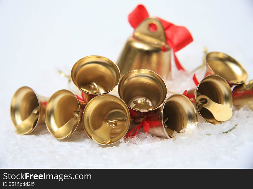 Gold christmas bells on snow. Gold christmas bells on snow