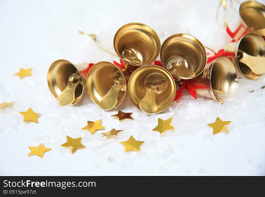 Christmas bells with golden stars in snow. Christmas bells with golden stars in snow